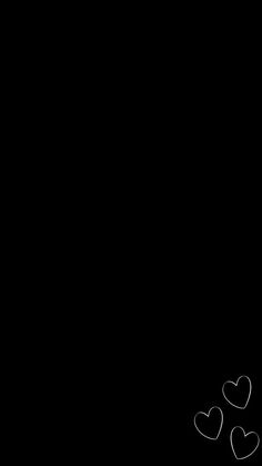 two hearts drawn in the middle of a black background with space for text or image