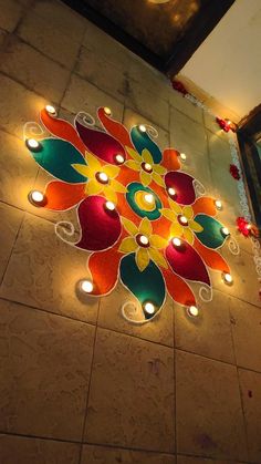 the floor is decorated with colorful lights and candles for diwaling or decorating