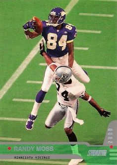 a football player jumping up into the air to catch a ball in front of another player