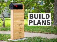 a mailbox sitting on the side of a sidewalk next to a sign that says build your own modern mailbox