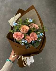 a person holding a bouquet of flowers in their hand