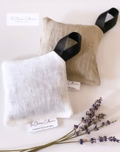 two pillows with black ribbon and lavender flowers