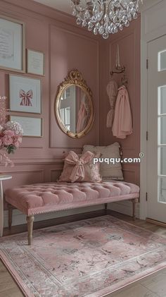 a pink room with a bench, chandelier and pictures on the wall