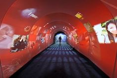 a long tunnel with pictures on the walls