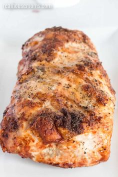 a piece of cooked meat sitting on top of a white plate