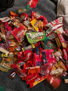 a pile of assorted candy on the floor