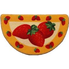 a yellow and red plate with three strawberries on the front, one has green leaves