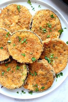 some fried food on a white plate with parsley