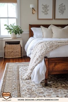 a bed with white linens and pillows in a bedroom next to a basket on the floor