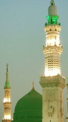 a large white and green building with lights on it's sides