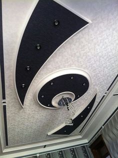 the ceiling is decorated with black, white and silver designs on it's walls