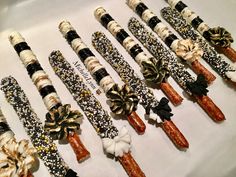 there are many different types of candy sticks on the table together, all decorated with bows and beads