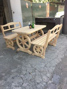 three wooden benches sitting next to each other in front of a building with a beer bottle on the table