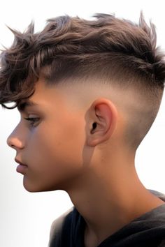 For boys seeking an effortless yet look the tousled top with skin fade is perfect. The sides feature a skin fade that beautifully complements the tousled top, which can be styled using sea salt spray for added texture and volume. Click here to check out more trendiest boys haircuts for school. Fade Haircut With Long Top, Boys Textured Haircut, Boy Hair Cuts Short Fade Long On Top, Boys Fluffy Haircut, Boys Hair Cut Long On Top Short On Sides, Boys Haircut Long On Top Short On Sides, Boy Haircut Long On Top Short On Sides, Boy Hair Cuts Short Fade, Boy Fade Haircut