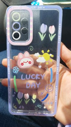 a person holding up a phone case with an image of some animals and flowers on it