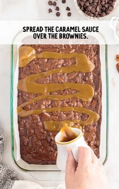 someone spreading caramel sauce over the brownies in a baking dish with coffee beans