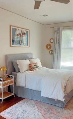 a bed sitting in a bedroom next to a window