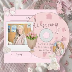 a pink cd cover with flowers on it and a bunny holding a flower in its hand