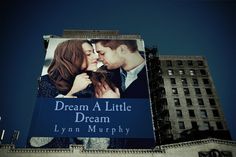 a large billboard with a couple kissing in front of a building