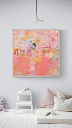 an abstract painting hangs on the wall above a white bed with pink and yellow pillows