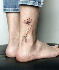 two people with tattoos on their legs and one has a flower tattoo on the ankle