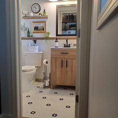 the bathroom is clean and ready for us to use it's new tile floor