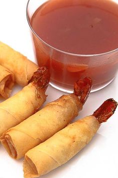 three pieces of food sitting next to a cup of tea