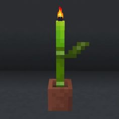 a small green cactus with a flame on it's head