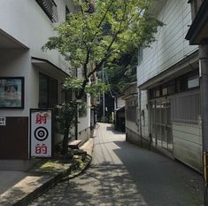 an alley way with buildings and trees on both sides