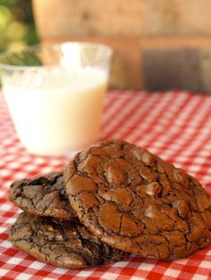 two cookies and a glass of milk on a table