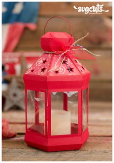 a small red lantern with a candle inside