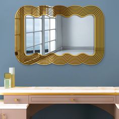 a mirror that is on the wall above a desk