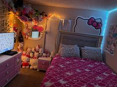 a bedroom with hello kitty decorations on the walls and lights above the bed, along with pink dressers