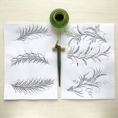 two sheets of paper with designs on them next to a green pen and ink roller