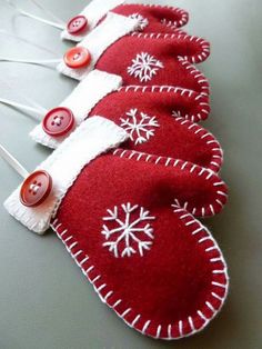 three red and white christmas stockings with snowflakes on them