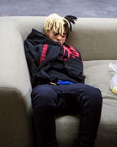 a person with dreadlocks sitting on a couch