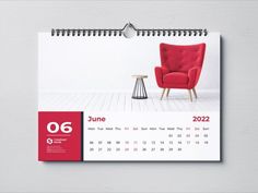 a wall calendar with a red chair and table in front of it on a white background