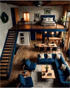 an overhead view of a living room with blue couches and wooden tables in it