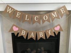 a welcome baby banner hanging over a fireplace