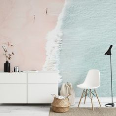 a living room with a white cabinet and pink wallpaper on the walls next to a chair