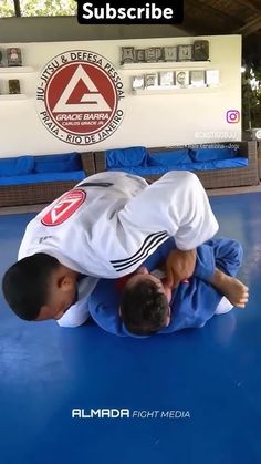 a man in white shirt and black pants on blue mat with words above him that says,