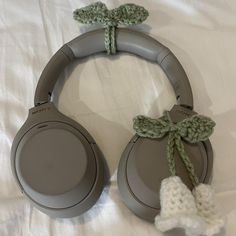 a pair of headphones that are laying on a bed