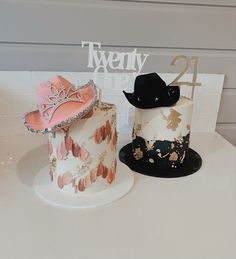 two cakes decorated with hats and decorations on top of each other for a 21st birthday