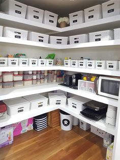 an organized pantry with white bins and baskets