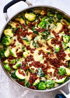 a pan filled with brussel sprouts covered in bacon and other toppings