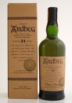 an empty bottle of ardbeg 21 year old whisky next to a cardboard box