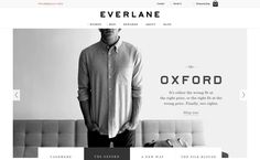 a man standing next to a couch in front of a wall with the words everlane on it