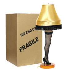 a lamp that is next to a cardboard box with the word fragile written on it