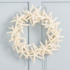 a white starfish wreath on a blue door