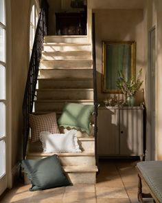 the stairs are lined with pillows and throw pillows